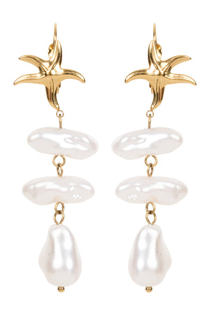 Gold and pearl drop earrings on a white background